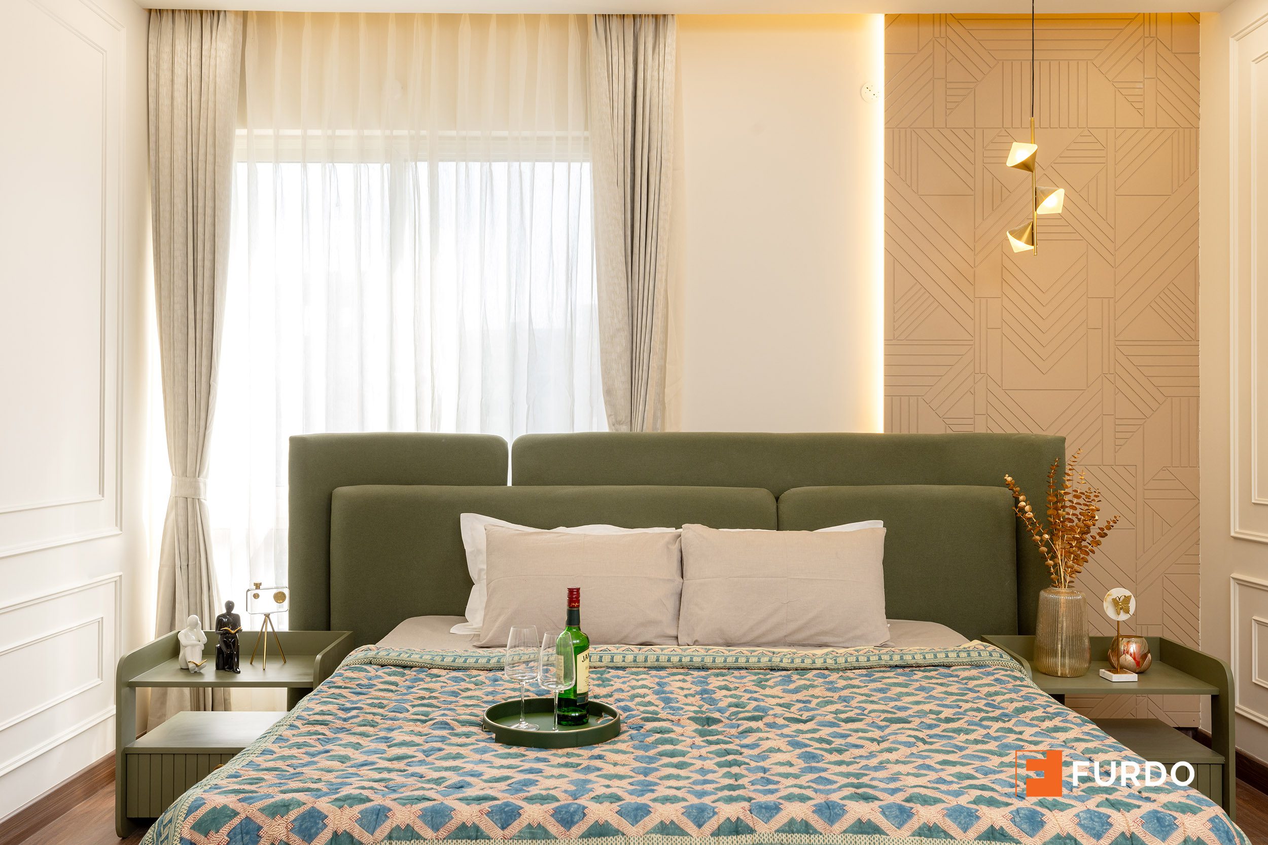 Luxury master bedroom interior design Hyderabad — Auro Kohinoor, upholstered green headboard, textured feature wall and layered lighting