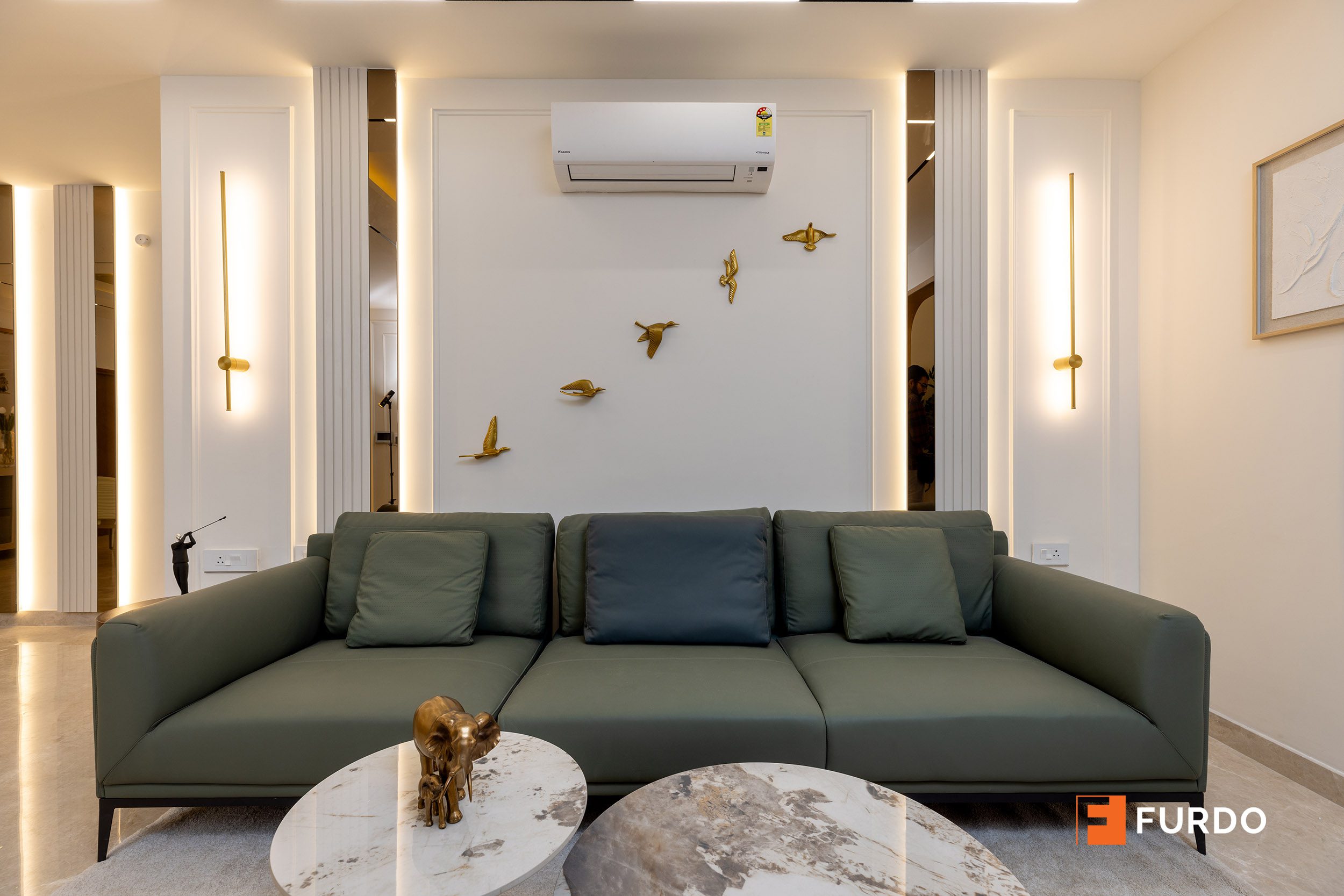 Green leather sofa with handloom cushion detailing in a luxury living room interior design, Hyderabad