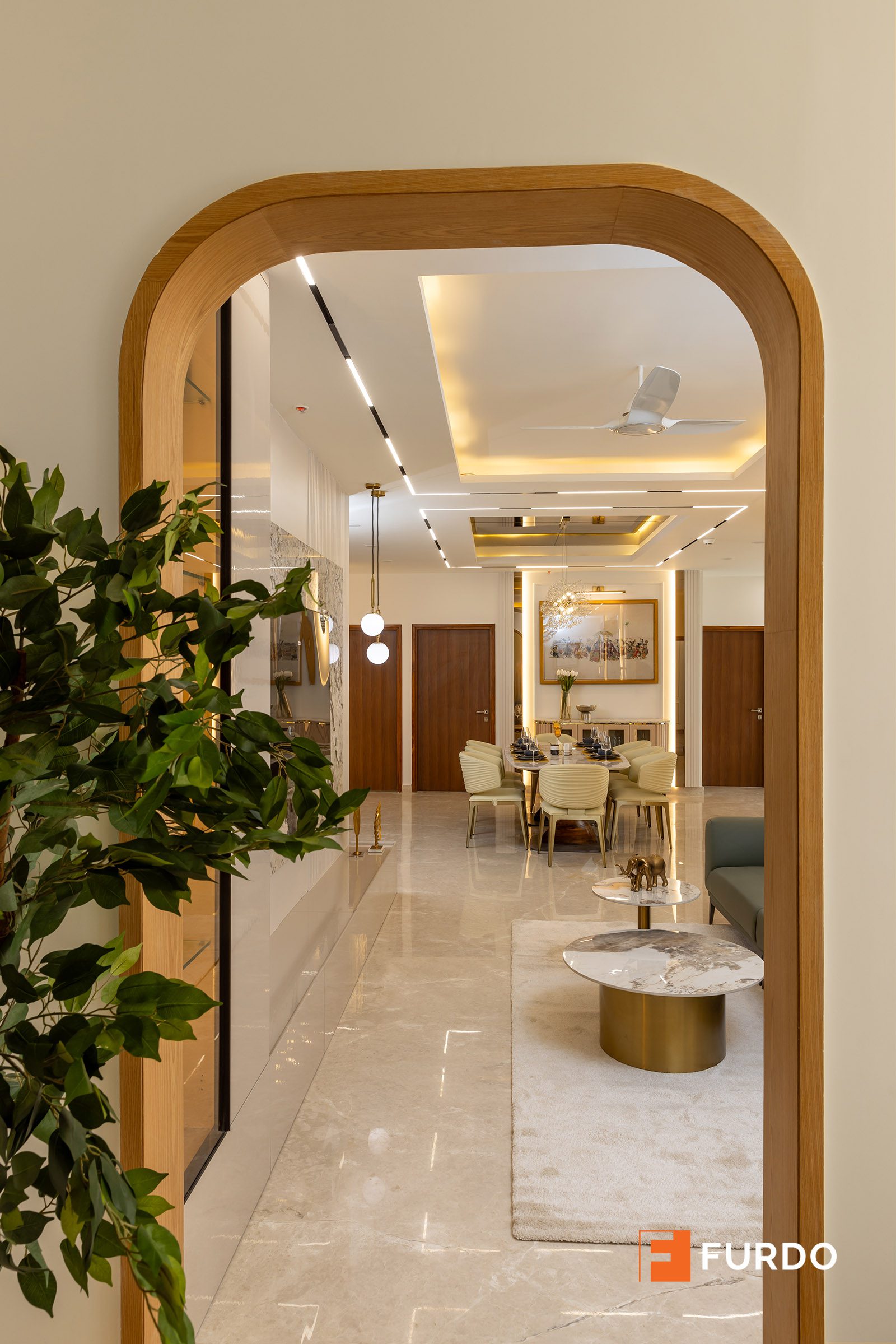 Luxury foyer and entryway interior design Hyderabad — Auro Kohinoor, an arched threshold framing the view into the living space