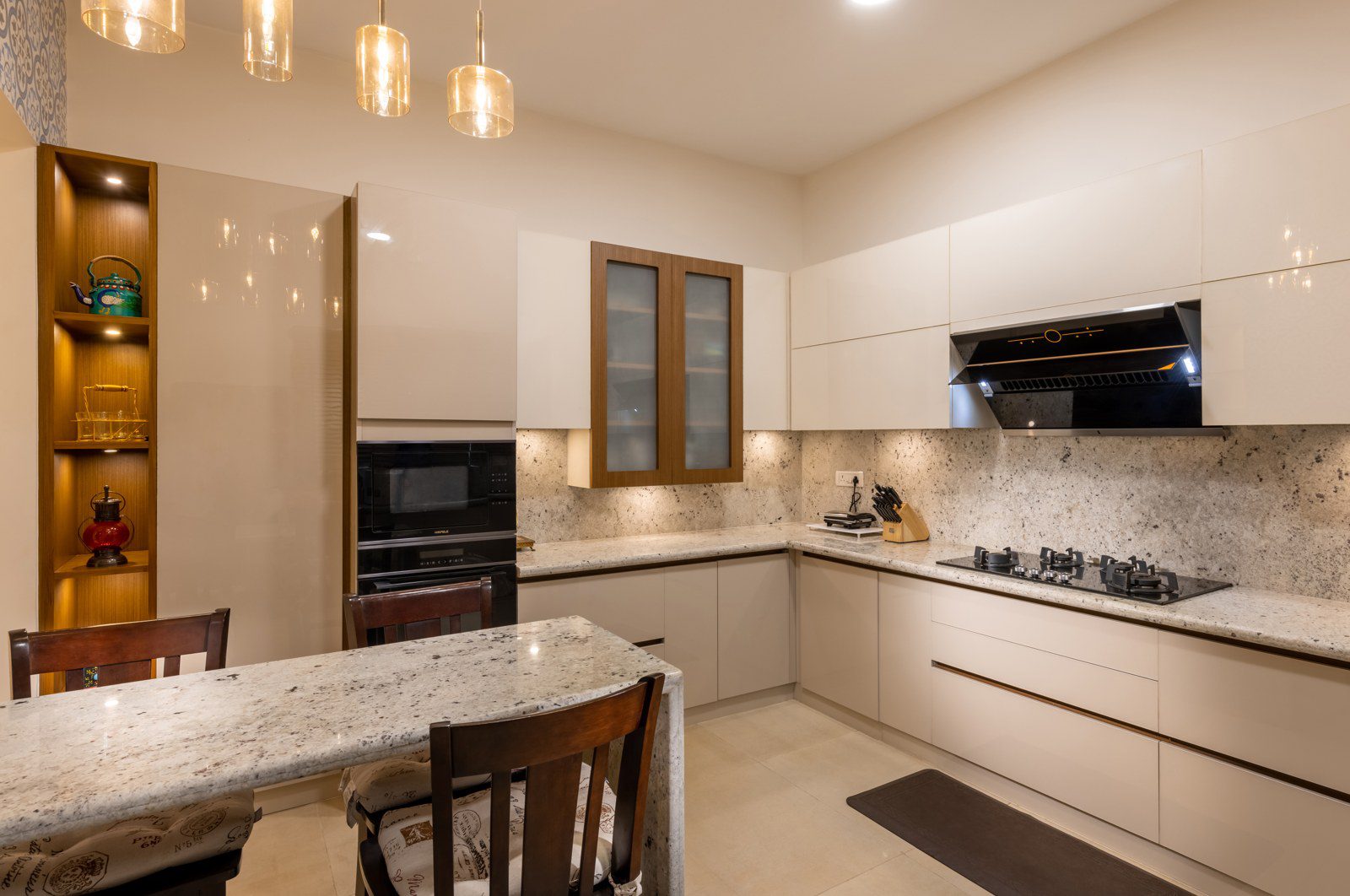 Modular kitchen design with granite countertop and built-in appliances in a Bangalore villa