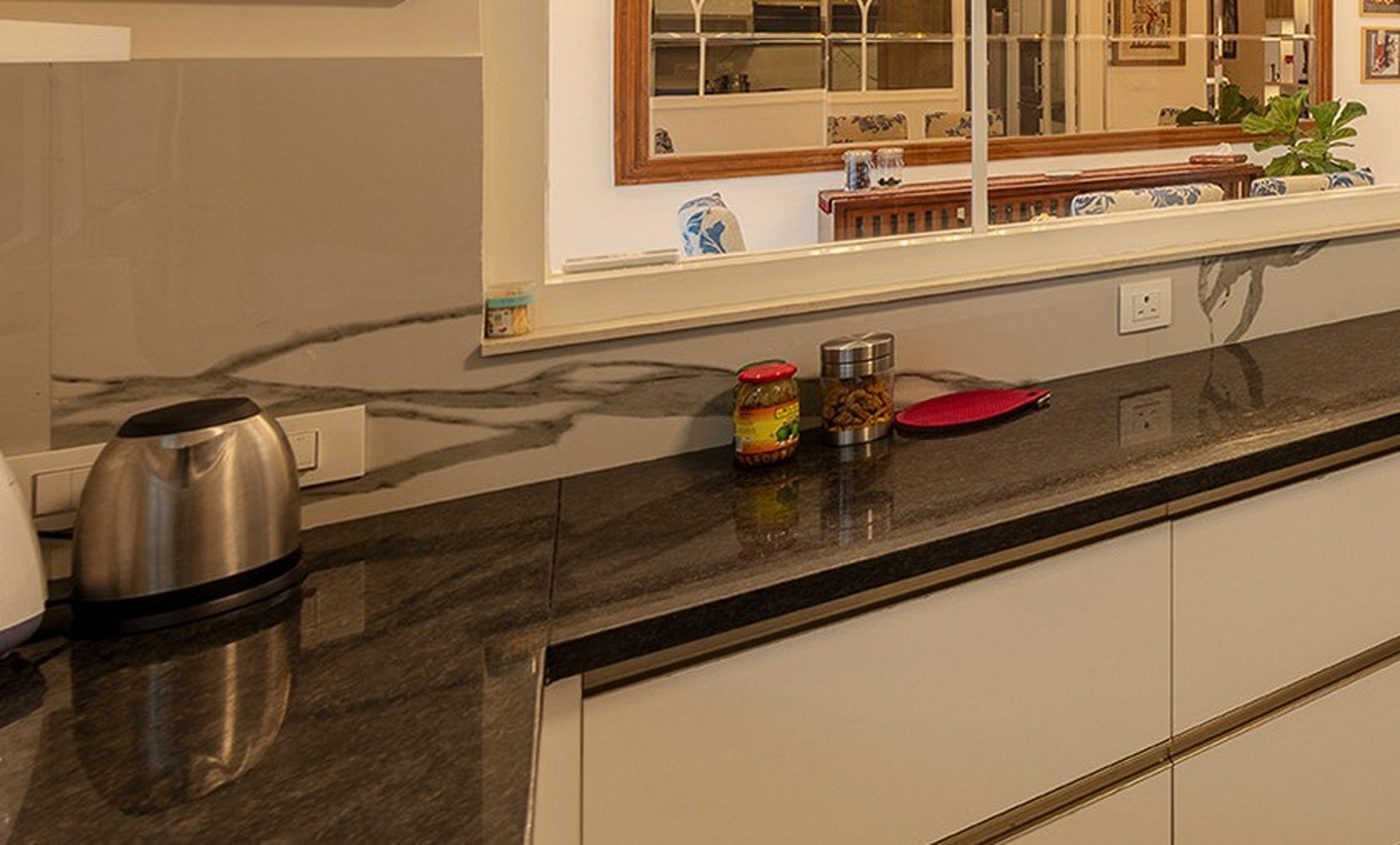 A dense, sealed granite counter surface in a kitchen, chosen for heat and stain resistance